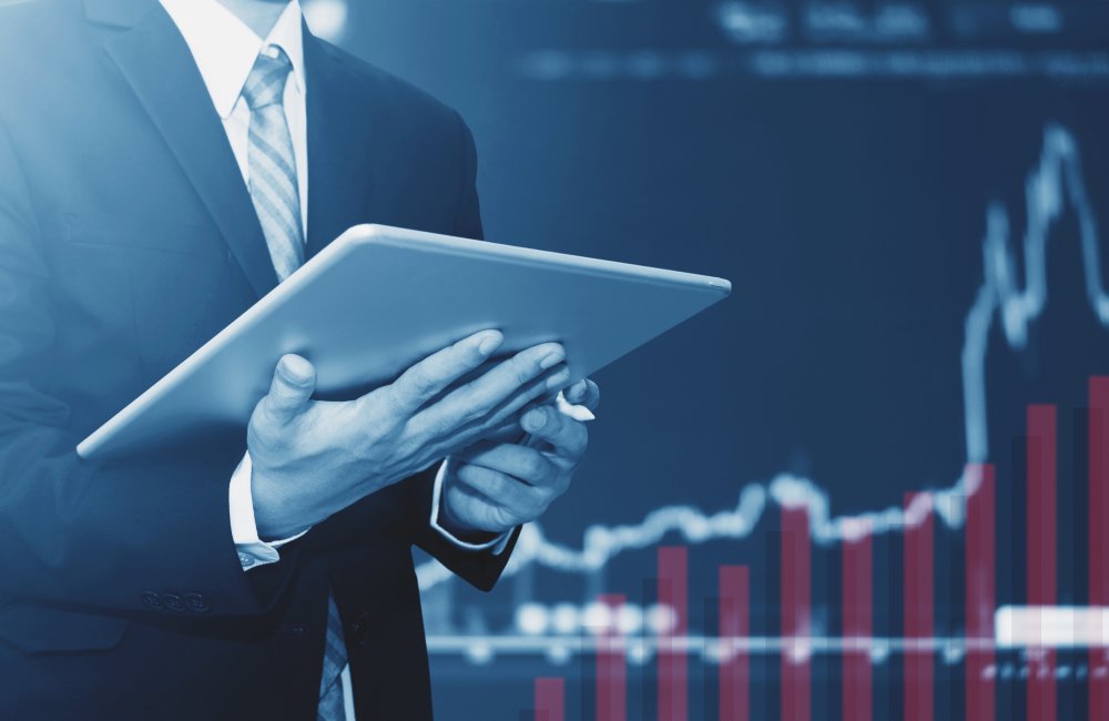 Businessman using digital tablet, raising graph background. Business growth, investment and invest in stock exchange market