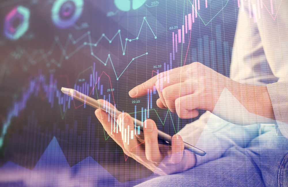 Double exposure of man's hands holding and using a digital device and forex graph drawing. Financial market concept.